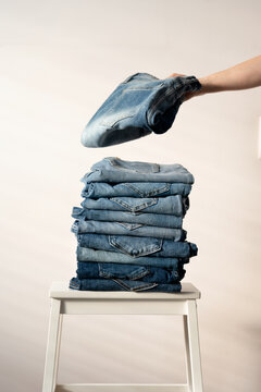 Neatly folded denim jeans on chair