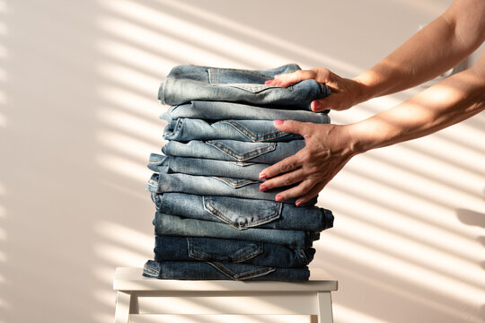 Neatly folded denim jeans on chair
