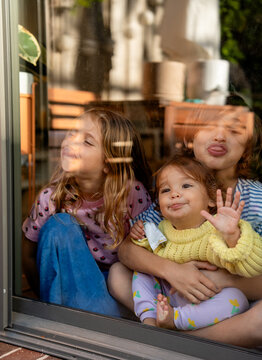 Kids kissing the window