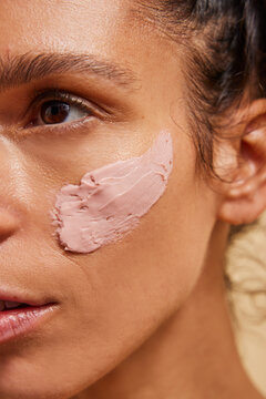 Woman with pink clay face mask 