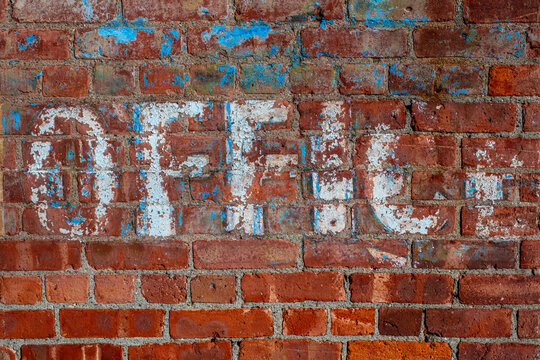 old colorful painted brick wall with word "office"