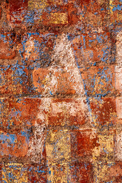 old colorful painted brick wall with large letter A stenciled on