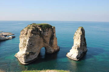 raouche rock in beirut in lebanon with blue sky and sea