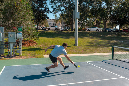 Man hitting the ball in a pickleball game