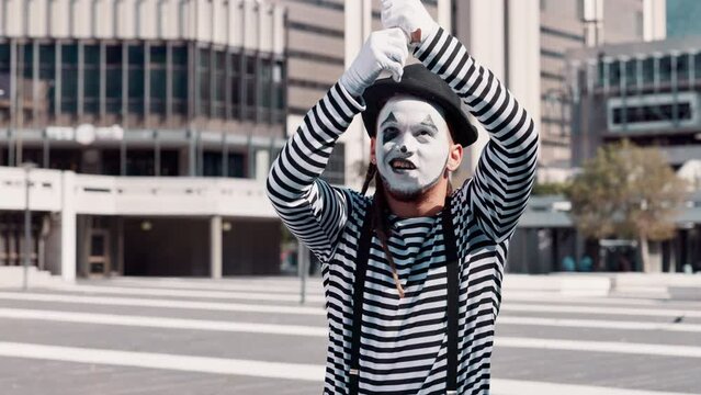 Mime, art and man in city with paint on face for performance, action and comedy outdoor. Artist, creativity and comic acting in urban street, wave hello in show and entertainment with mask for fun