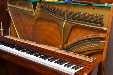 a disassembled old piano prepared for repair and tuning