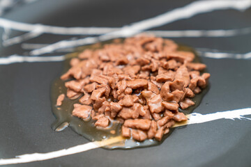 Food for animals background. wet cat and dog food texture, pattern. Pet meal background close up. wet food for pet dogs and cats. Dried pet food top view. Granules of good nutrition for dogs and cats.