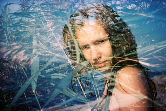 portrait of a woman with reeds in double exposure