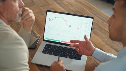 Financial advisor explaining invest stock market data consulting investor working in office. Stock market traders working on financial chart analysis using laptop. Hands pointing on screen close up.