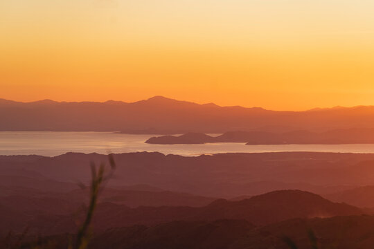 Image of one side and mountains around with a sunset