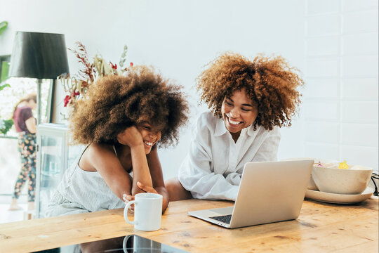 Joyful mother and daughter enjoying time together at home