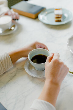 Women's hands with a cup of coffee