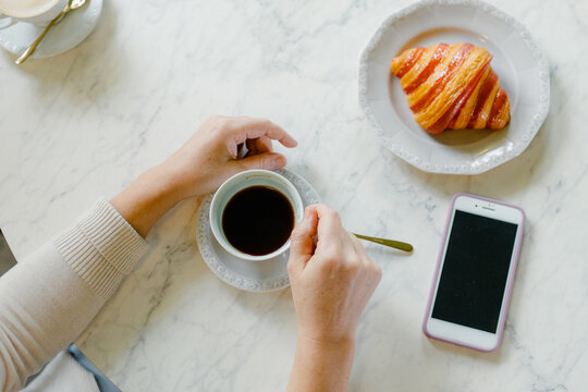 Women's hands with a cup of coffee