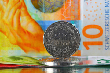 A two-franc coin and a ten-franc note stand out from other Swiss money