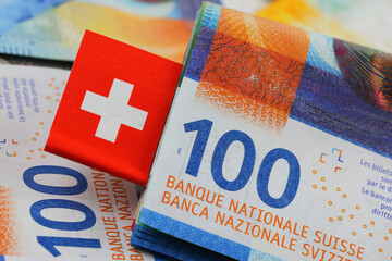 Swiss flag and hundred franc banknotes