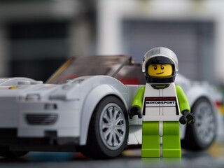 Fototapeta premium Tambov, Russian Federation - February 20, 2024 Lego Porsche 918 Spyder driver minifigure and his car by LEGO Speed Champions.