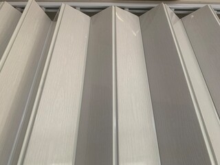white PVC or plastic folding door hand, room divider blinds or hanging curtain
