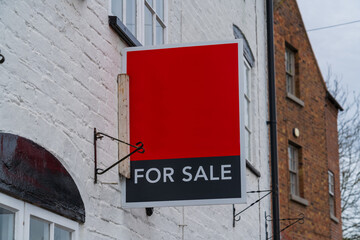 Red and Black for sale sign on the side of a house, New house purchase concept