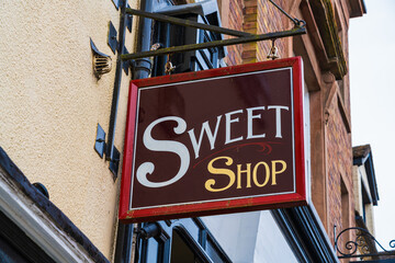 Sign board for a sweet shop, Hanging sign outside a candy store