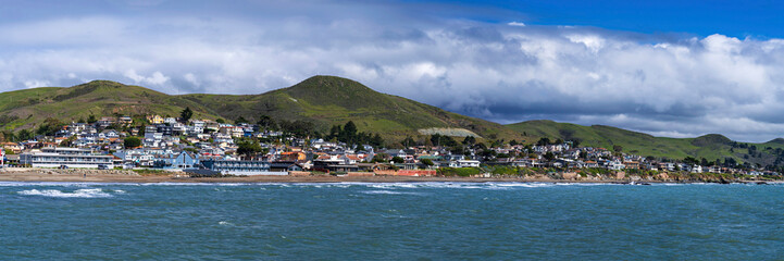 Fototapeta na wymiar Panorama of beach, ocean city on coast with hills
