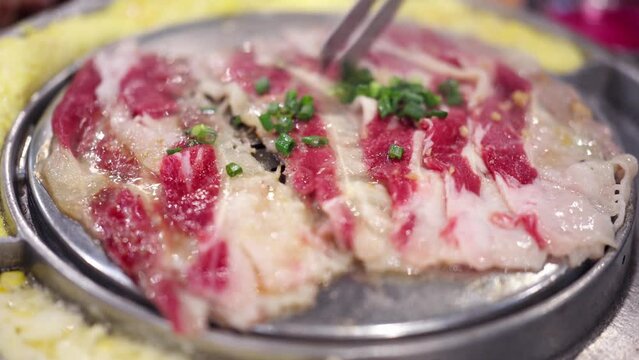 Let&rsquo;s eat Korean barbecue tonight. The charcoal is burning red. The fat beef rolls, beef and steak are grilled on the barbecue grill. The fat and oil are splashed out, and the aroma is delicious.