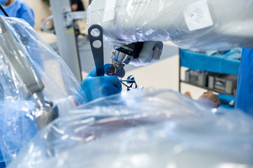 Team of doctor perform total hip arthroplasty replacement surgery in osteoarthritis patient inside the operating room. robot-assisted - robotic hip and knee replacement surgery	