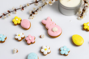 Easter cookies and cherry blooming branches on white background