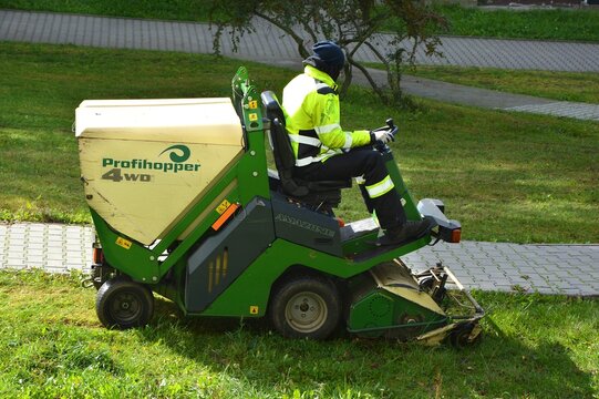 Kielce, Świętokrzyskie, Poland - 2022-10-15 - Amazone Profihopper 4WD flail mower diesel 25 KMA - man mows the grass with a sitting machine, very efficient, one of the best machines in the world