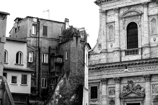 View of the Basilica of San Giovanni Battista dei Fiorentini in Rome, in the foreground an old semi-ruined palace. Black and white photos.