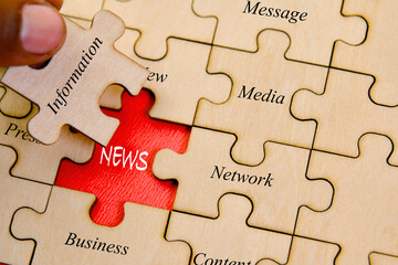 Close up of puzzle pieces with word NEWS Business concept image