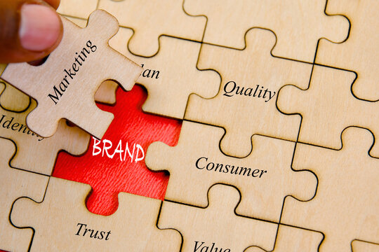 Jigsaw puzzle pieces with the word BRAND QUALITY CONCEPT