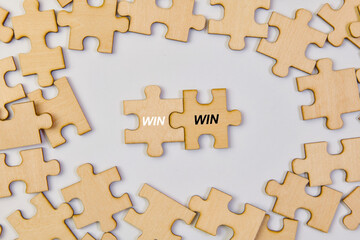 Jigsaw puzzle pieces with the word win business success concept