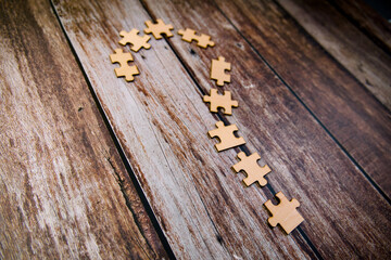 Question mark made of wooden puzzle pieces on old wooden background business and strategy concept