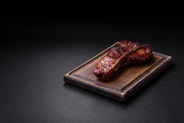 Delicious juicy beef tbone steak with salt, spices and herbs