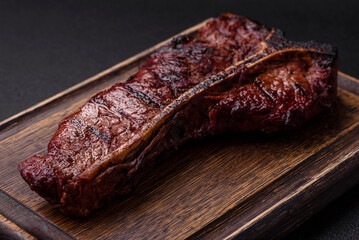 Delicious juicy beef tbone steak with salt, spices and herbs
