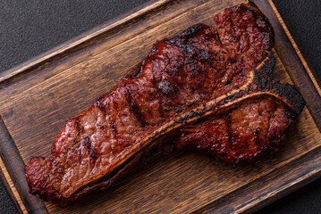 Delicious juicy beef tbone steak with salt, spices and herbs