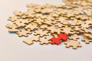 Puzzle pieces with one different colour piece, conceptual image of finding a puzzle