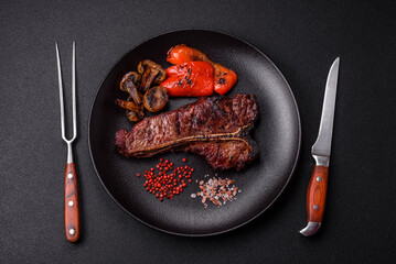 Delicious juicy beef tbone steak with salt, spices and herbs