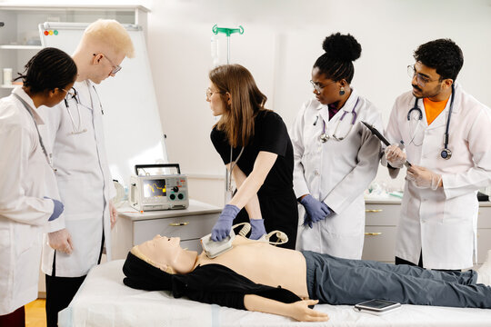 Instructor teaching first aid cardiopulmonary resuscitation course and use of automated external defibrillator workshop