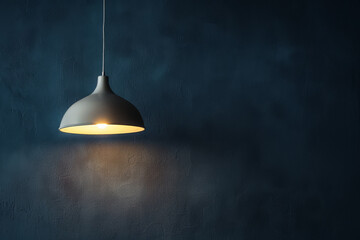 A lamp hangs against a dark wall, casting its light and illuminating the area, with space available for text or presentation.