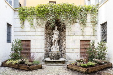 The original statue of Neptune in the courtyard of Trento town hall at Thun Palace. Trentino-Alto Adige, Italy © cabuscaa