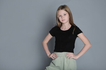 Poised and self-possessed, a young girl faces the camera. She represents the new generation's...