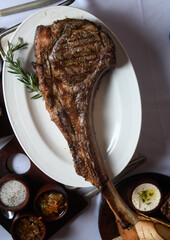 Tomahawk piece of meat in a dish