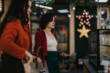 Business professionals engage in a discussion near a cafe adorned with a star decoration,...