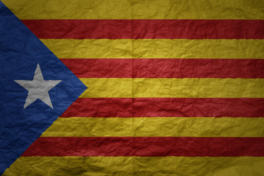 big national flag of catalonia on a grunge old paper texture background