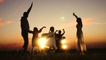 Family party in nature by car, children kids parents dancing together enjoying summer time fun company. Kids sons daughters mom dad having good time with music by car big family travelling road trip