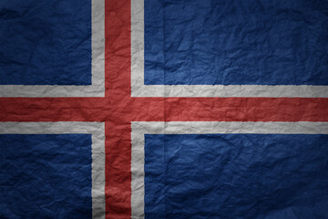 big national flag of iceland on a grunge old paper texture background