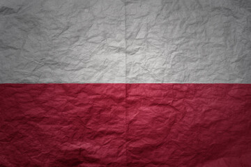 big national flag of poland on a grunge old paper texture background