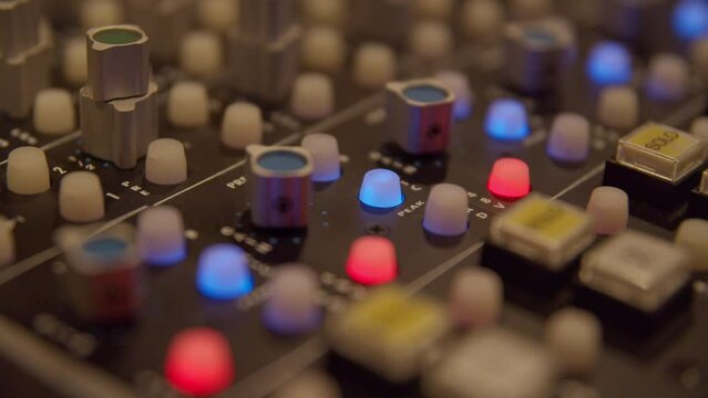 Mixing console knobs and buttons in recording studio