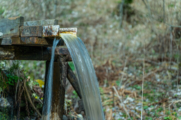 water flows through the chute of a watermill